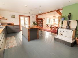 A kitchen with an island and dining area at Shanti Gher in Bantry