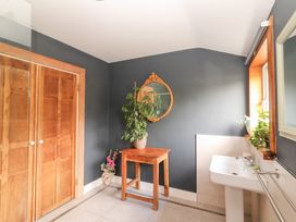 A bathroom with a sink and wooden table at Shanti Gher in Bantry