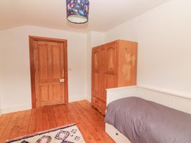 A bedroom with a wardrobe and single bed at Shanti Gher in Bantry