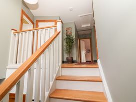 A staircase with a potted plant and wall art at Shanti Gher in Bantry