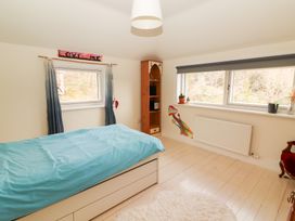 A bedroom with a bed and shelf at Shanti Gher in Bantry