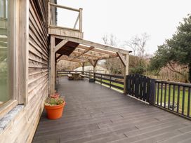 An outdoor deck with wooden structure and potted plants at Shanti Gher in Bantry