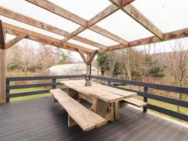 An outdoor area with a wooden table and benches at Shanti Gher in Bantry
