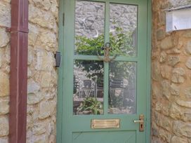 A green door with an anchor decoration at Drake's Hideaway in Lyme Regis