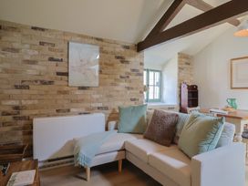A living room with a sofa and table at Drake's Hideaway in Lyme Regis