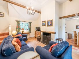 A living room with a television and fireplace at The Coach House in Lydford
