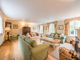 A living room with a sofa, table, and lamp at The Coach House in Lydford