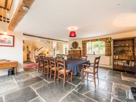 A dining room with a large table and chairs at The Coach House in Lydford