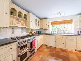 A kitchen with cabinets and appliances at The Coach House in Lydford