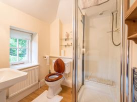 A bathroom with a toilet, shower, and sink at The Coach House in Lydford