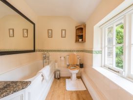 A bathroom with a bathtub and toilet at The Coach House in Lydford