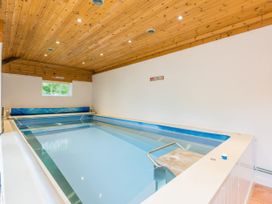 An indoor pool with wooden ceiling at The Coach House in Lydford