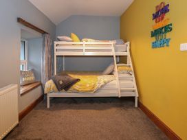 A bedroom with bunk beds and a window seat at Miners Rest in Blaenau Ffestiniog