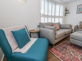 A living room with a sofa and armchair at Betty's Buoy in Weymouth
