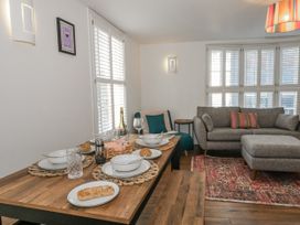 A dining room with a table set for a meal at Betty's Buoy in Weymouth