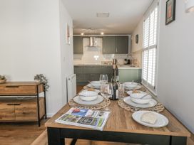 A dining room with a table set for a meal at Betty's Buoy in Weymouth