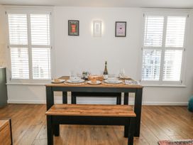 A dining area with a table set for a meal at Betty's Buoy in Weymouth