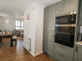 A kitchen featuring an oven and cupboard at Betty's Buoy in Weymouth