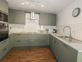 A kitchen with cabinets and appliances at Betty's Buoy in Weymouth