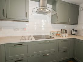 A kitchen with cabinets and appliances at Betty's Buoy in Weymouth