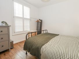A bedroom with a bed and dresser at Betty's Buoy in Weymouth