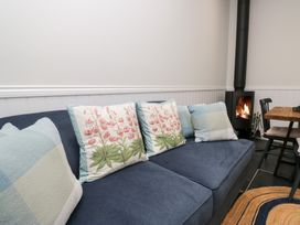 A living room with a sofa and fireplace at Pippins in Ambleside