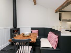 A dining area with a wooden table and seating at Pippins in Ambleside