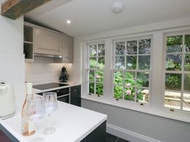 A kitchen with cabinets and stove at Pippins in Ambleside