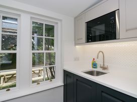 A kitchen with a sink and microwave at Pippins in Ambleside