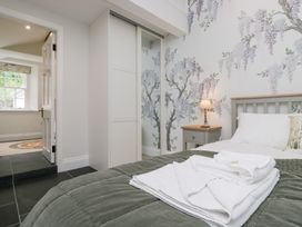 A bedroom with a bed and a wardrobe at Pippins in Ambleside