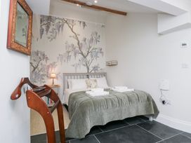 A bedroom with a bed and bedside table at Pippins in Ambleside