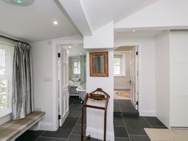 A hallway with a mirror and a bench at Pippins in Ambleside
