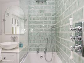 A bathroom with a bathtub and sink at Pippins Ambleside