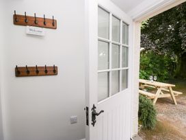 An entrance area with coat hooks and a view of a picnic table at Pippins in Ambleside