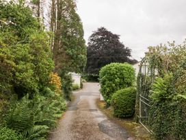 A pathway surrounded by bushes and trees at Pippins in Ambleside