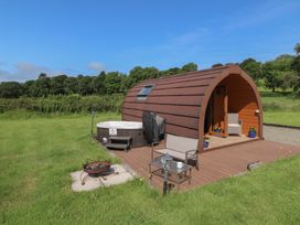 An outdoor area with a wooden building and hot tub at Ty Twt Teifi in Tregaron