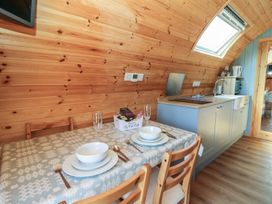 A dining room with a table set for two at Ty Twt Teifi in Tregaron