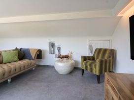 A living room with a sofa and an armchair at Number 7 in Bishop Sutton