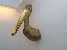 A pelican sculpture mounted on a wall at Number 7 Bishop Sutton