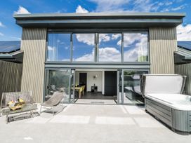 An outdoor area with a hot tub and seating at Number 7 Bishop Sutton