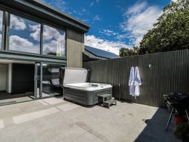 An outdoor area with a hot tub and a sliding glass door at Number 7 in Bishop Sutton