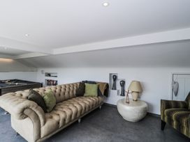 A snug with a sofa and armchair at Number 7 Bishop Sutton