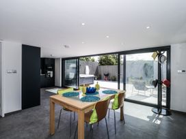 A dining room with a table and chairs leading to an outdoor area at Number 7 Bishop Sutton