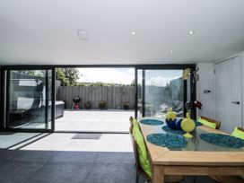 A dining room with a glass door leading to an outdoor area at Number 7 in Bishop Sutton