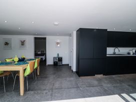A kitchen with a dining area and black cabinets at Number 7 Bishop Sutton