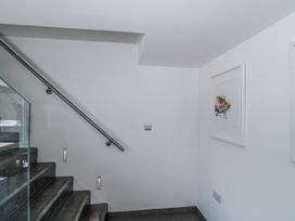 A staircase with railing and artwork on the wall at Number 7 in Bishop Sutton