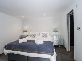 A bedroom with two beds and nightstands at Number 7 in Bishop Sutton