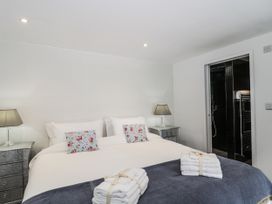 A bedroom with a bed and towels at Number 7 in Bishop Sutton
