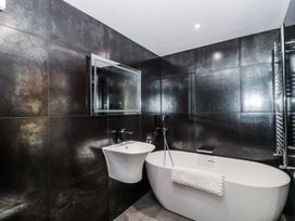 A bathroom with a bathtub and sink at Number 7 Bishop Sutton