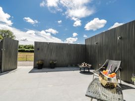 An outdoor patio with seating and planters at Number 7 in Bishop Sutton